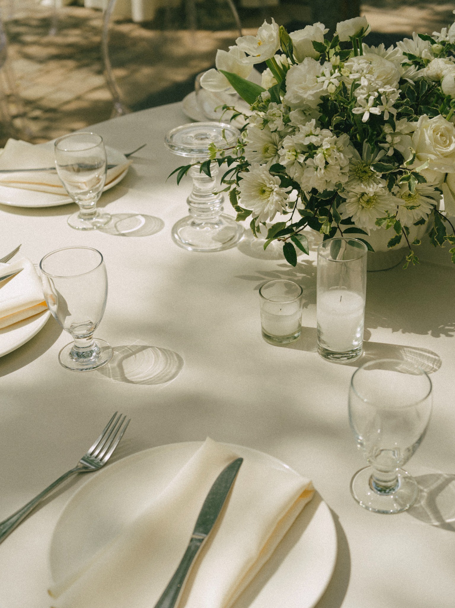 Cream linens and white floral table arrangements